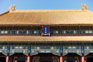 a building with a blue sign hanging from it's side