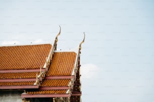 the roof of a building with a bird sitting on top of it