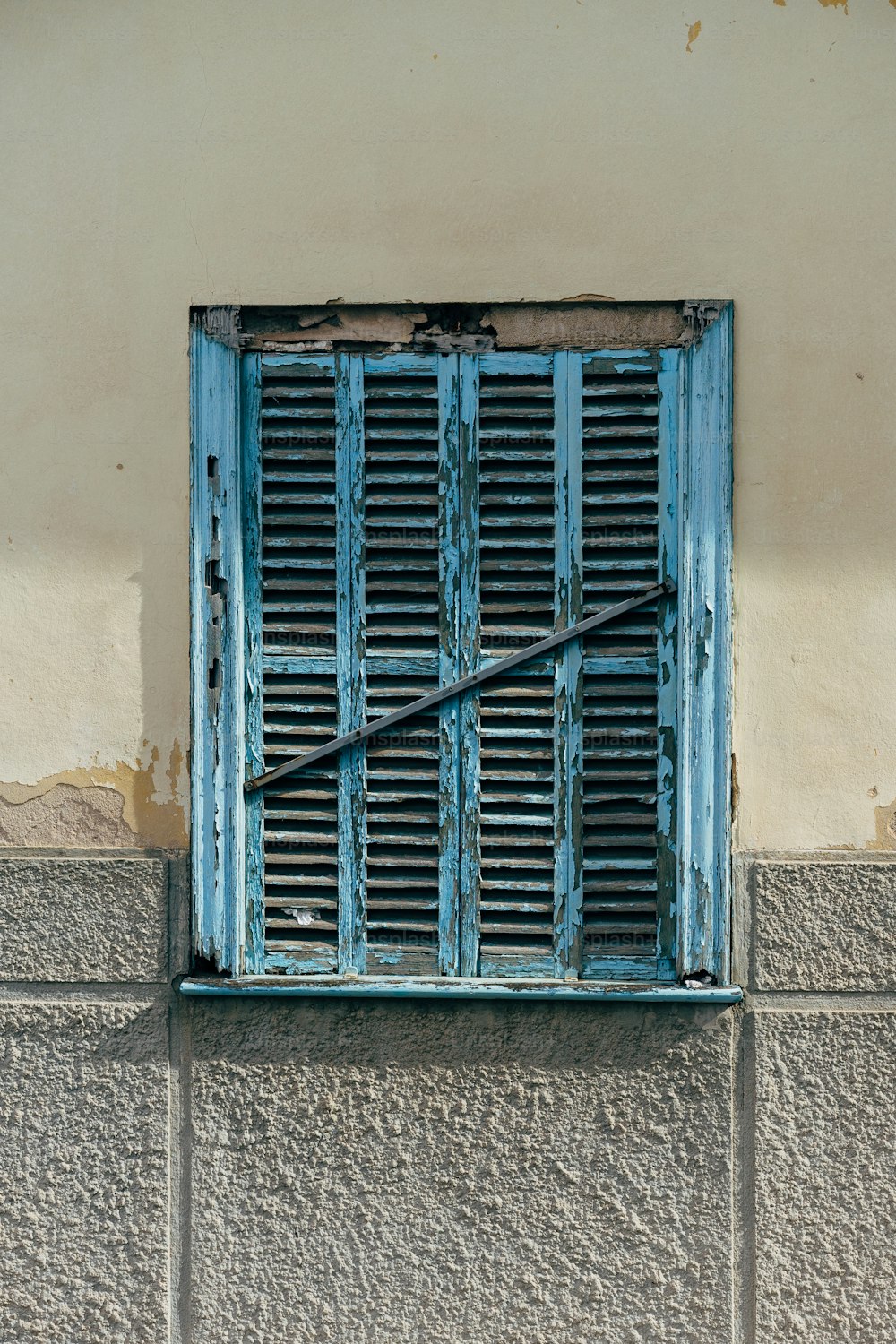 ein blaues Fenster mit einem langen Stock, der herausragt