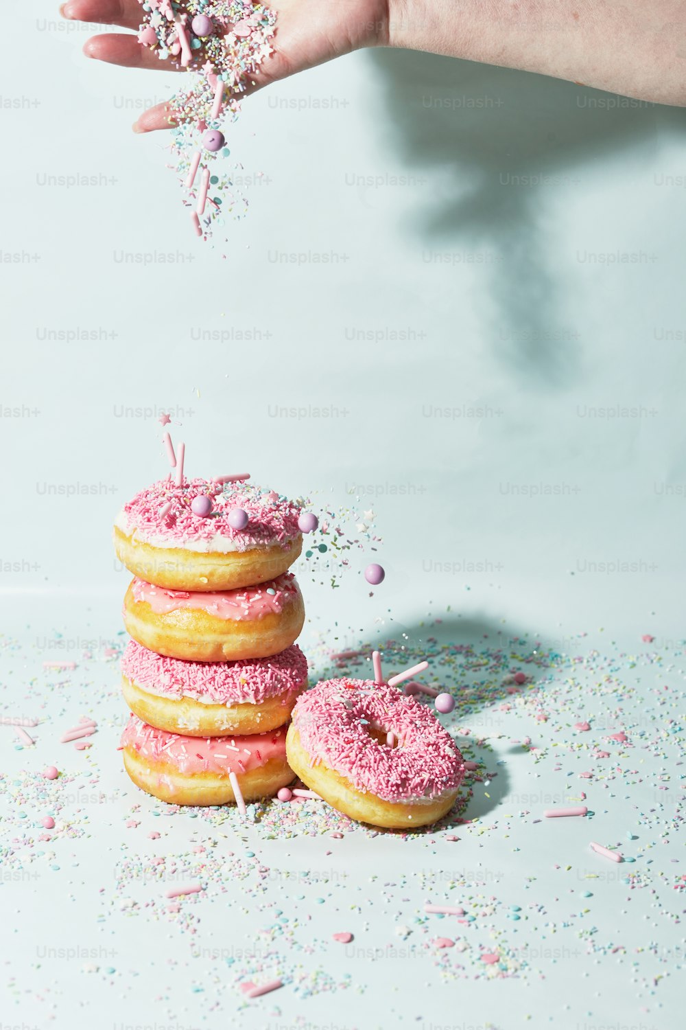 a stack of doughnuts with sprinkles and sprinkles