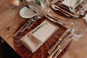 a table set with silverware and a menu
