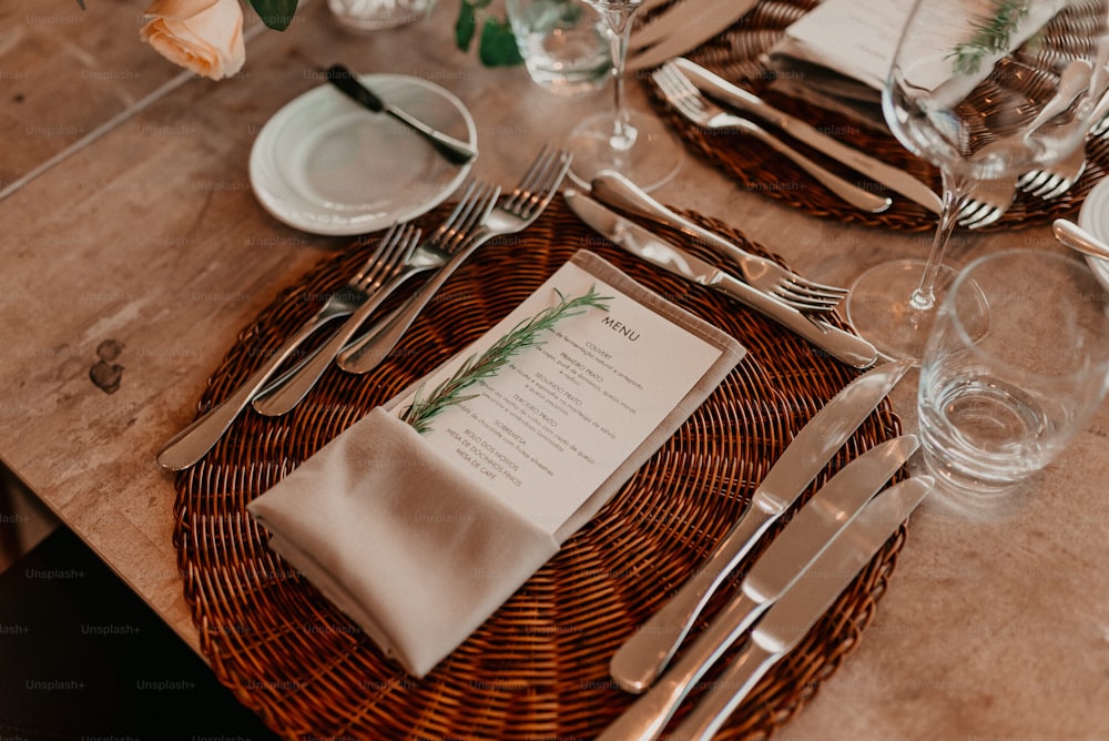 a table set with silverware and a menu