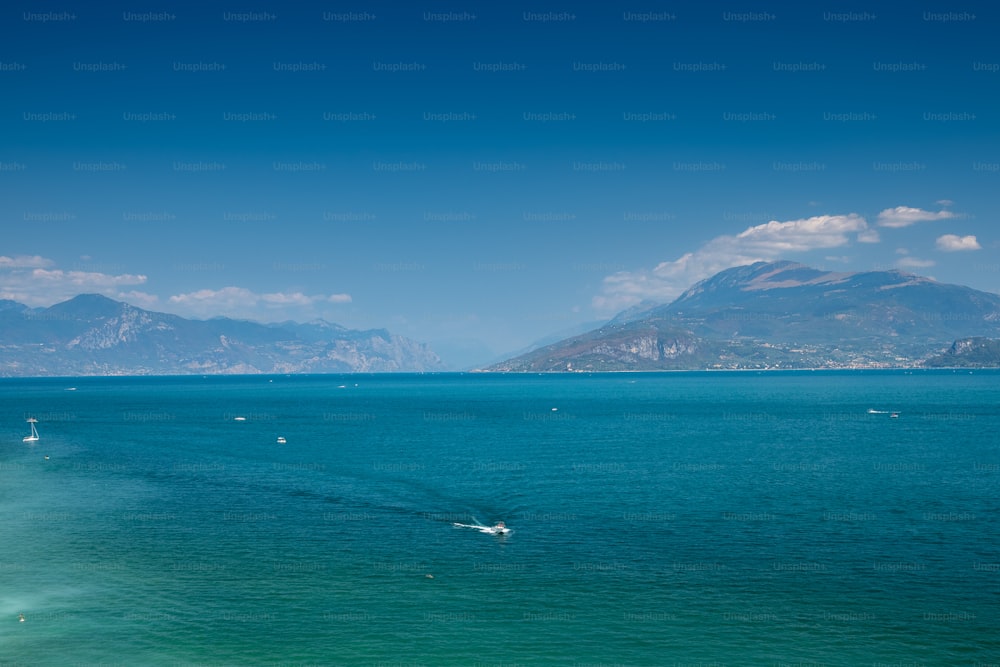 a large body of water with mountains in the background