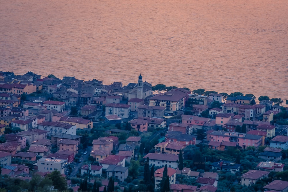 a view of a town with a body of water in the background