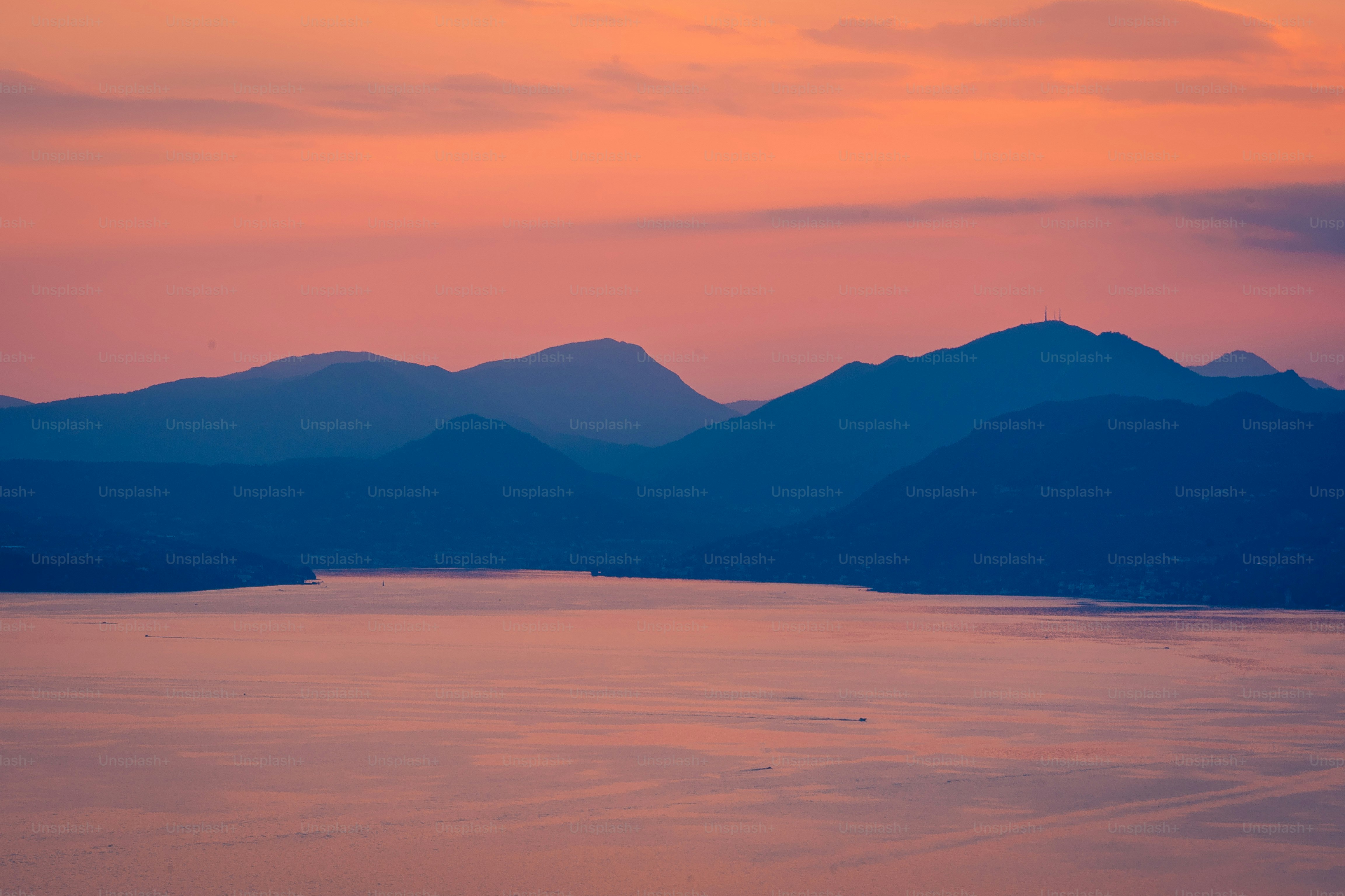 a large body of water with mountains in the background