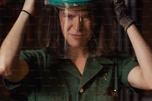a woman wearing a hard hat and green shirt
