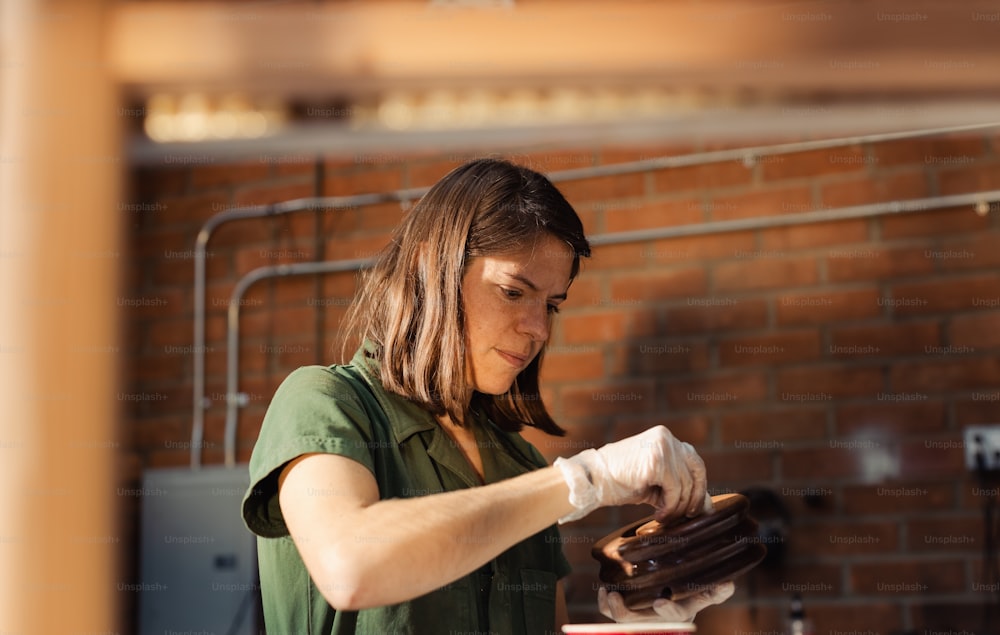 a woman in a green shirt is making cookies