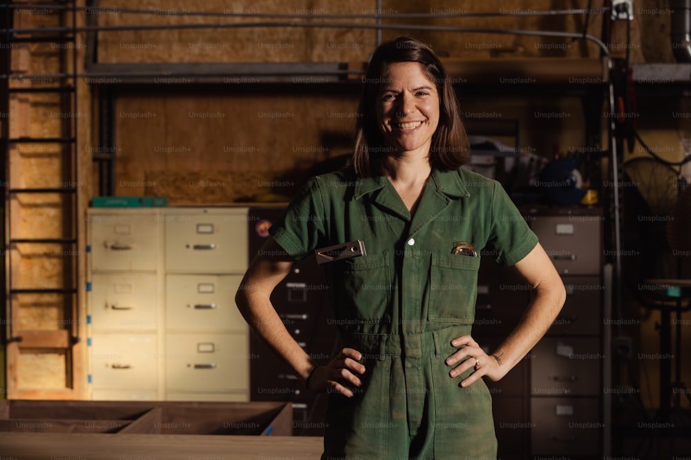 a woman in a green uniform standing in a room