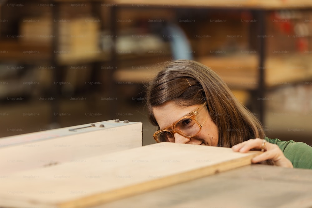 a woman working on a piece of wood