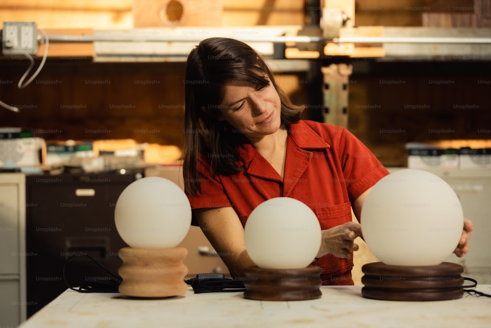 a woman working on a lamp in a workshop