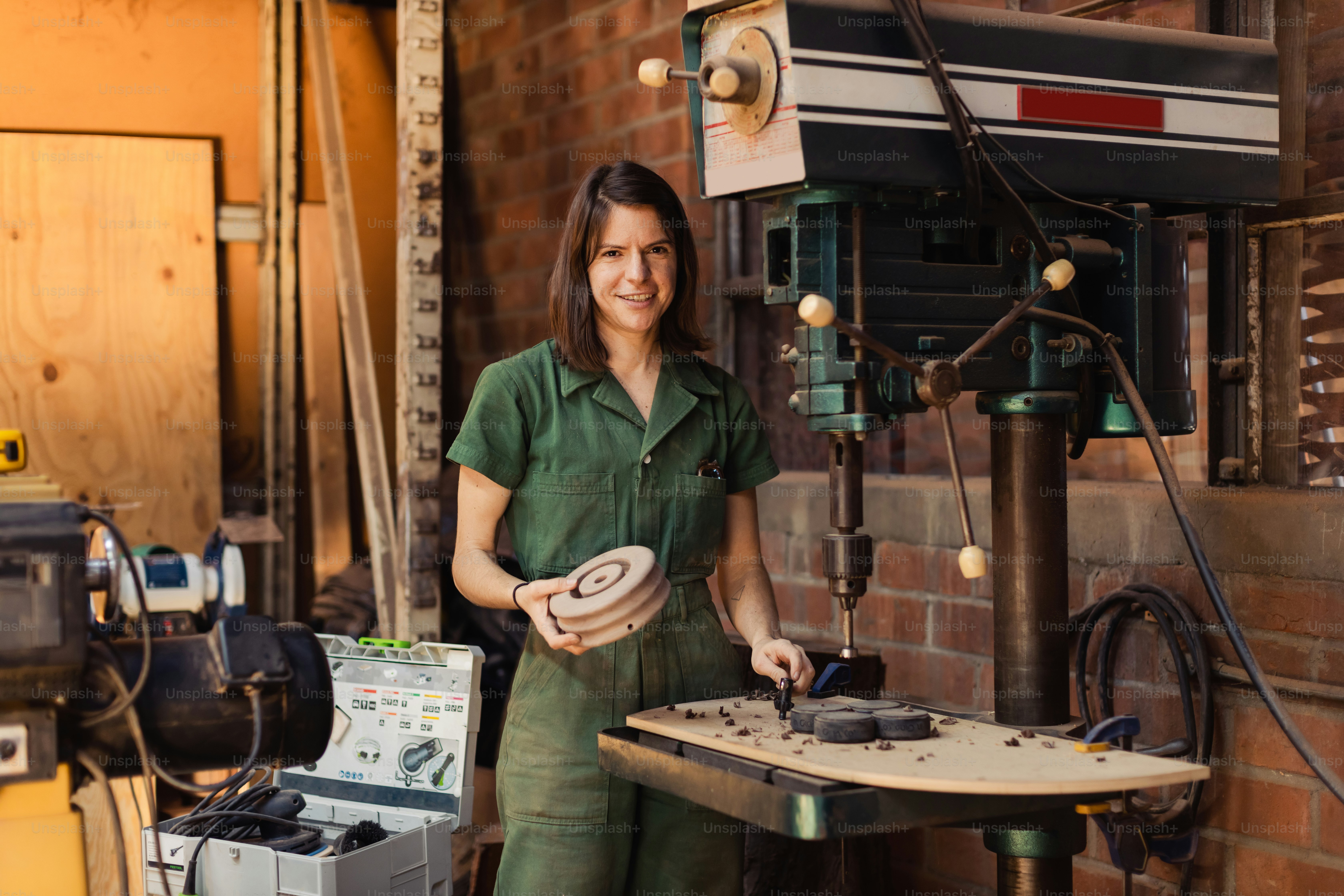 a woman in a green shirt is holding a frisbee