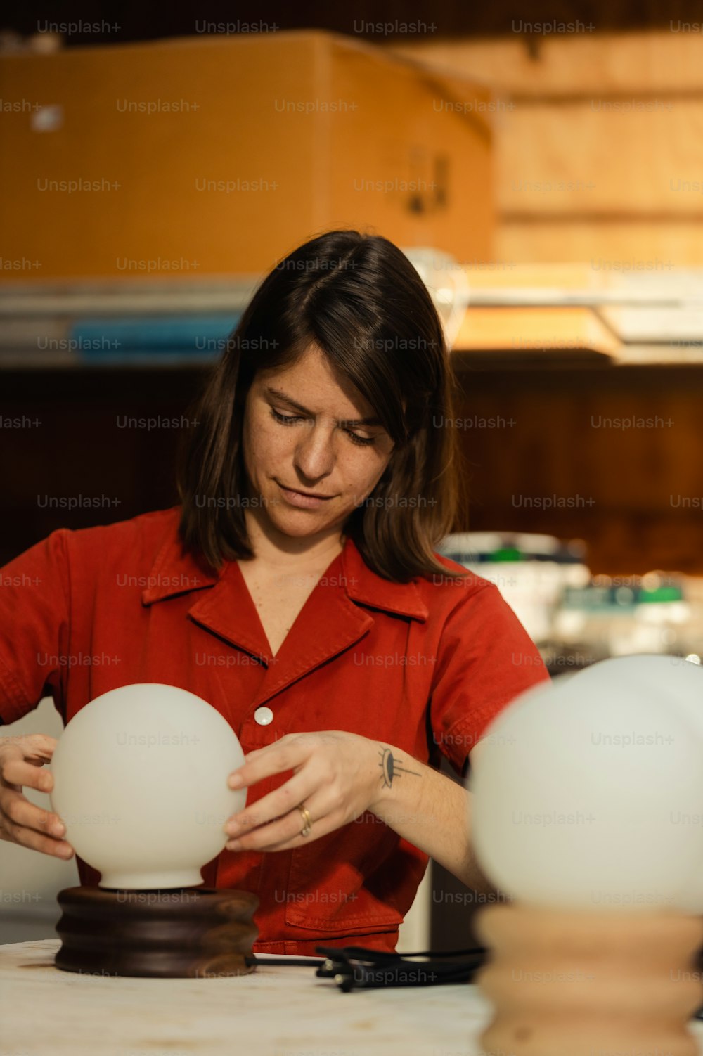 a woman in a red shirt is looking at three eggs