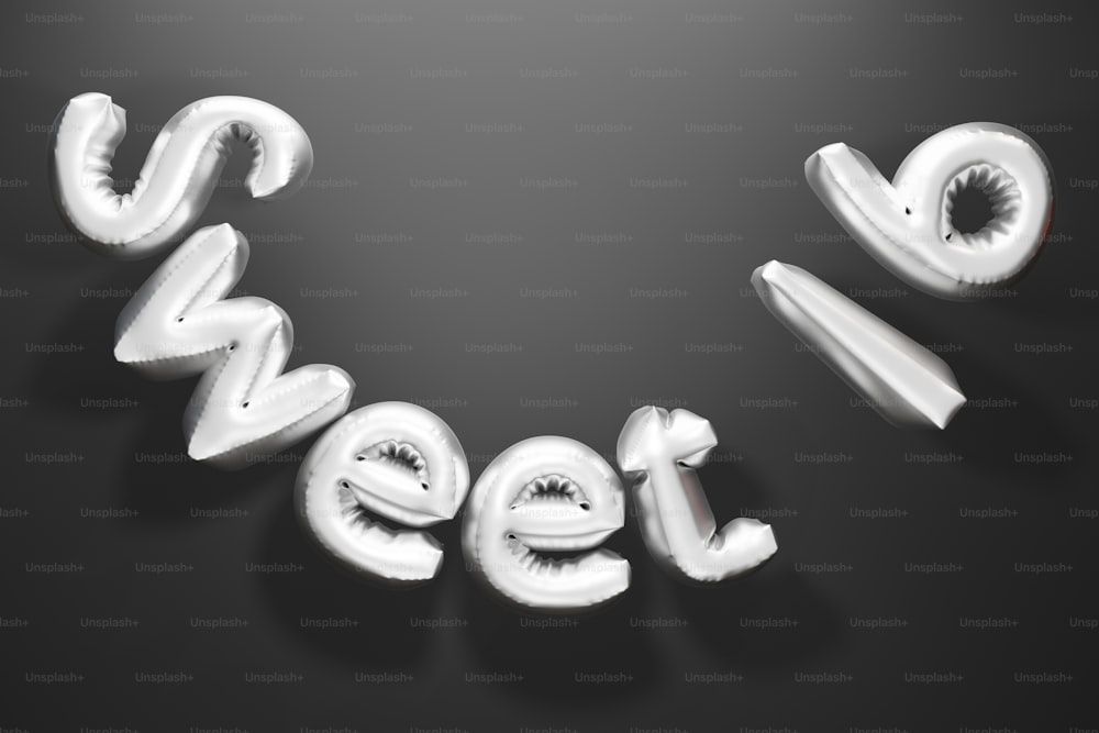 Una foto en blanco y negro de la palabra dulce deletreada de globos