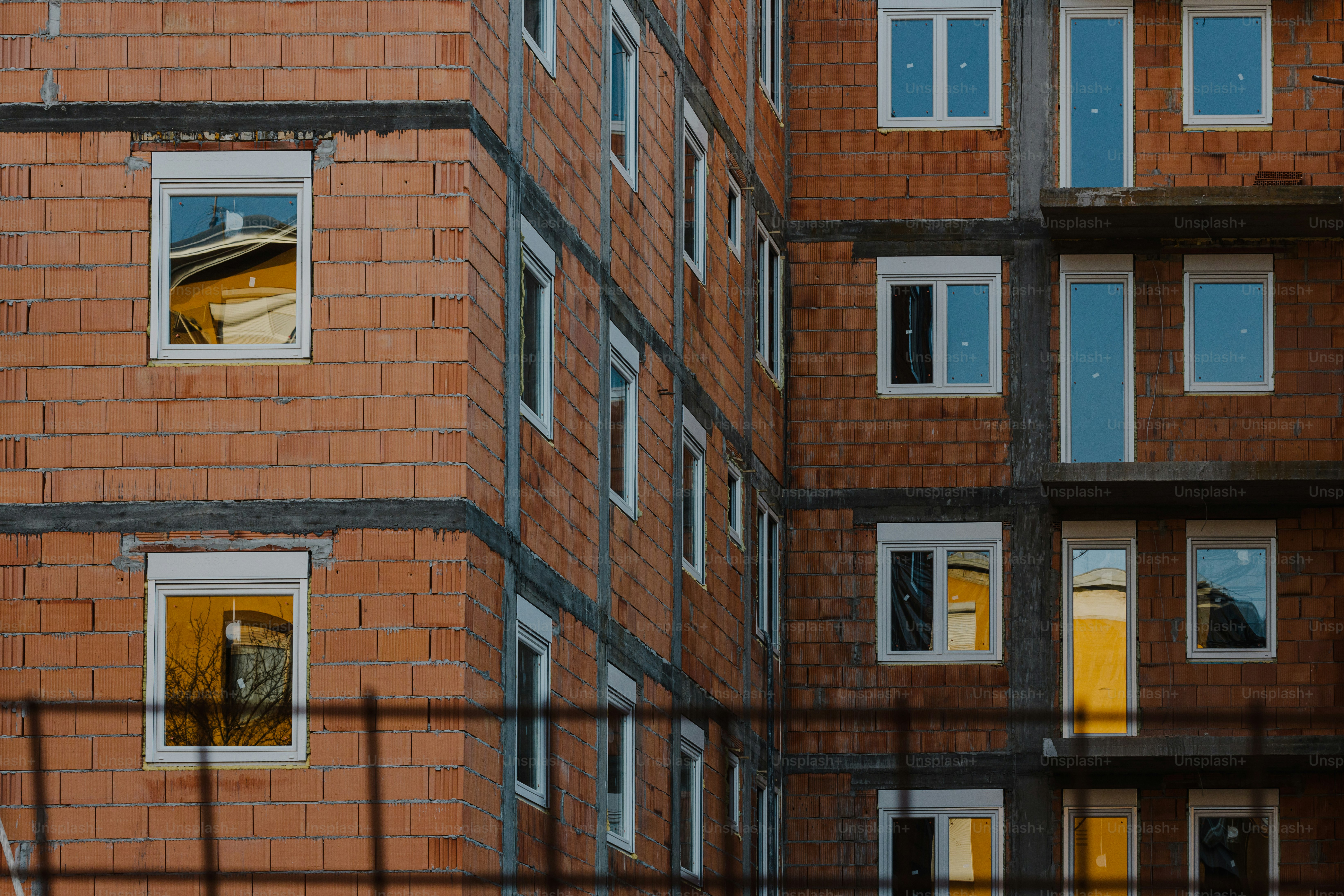 a red brick building with a yellow window