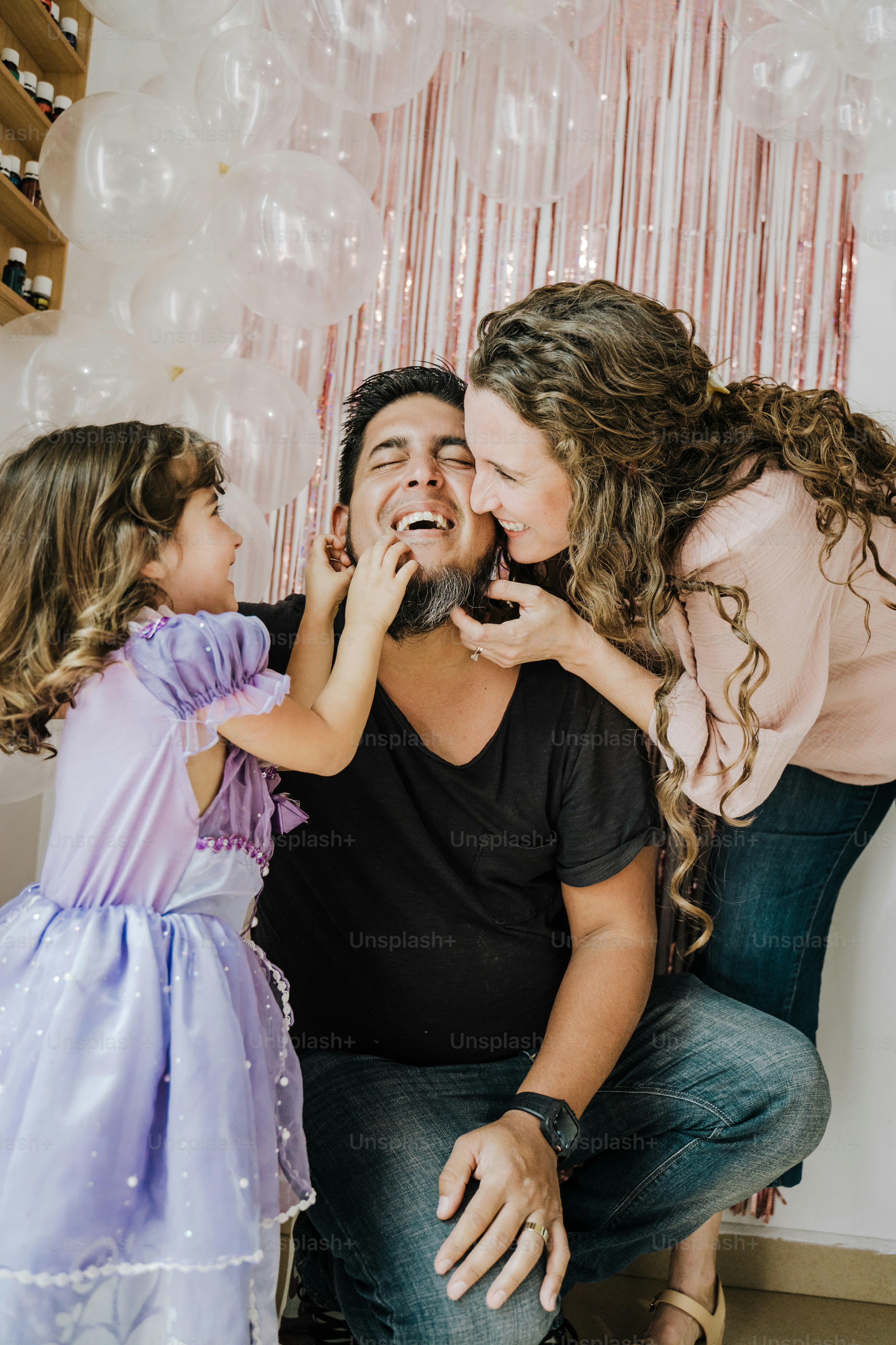 a man and two little girls standing next to each other