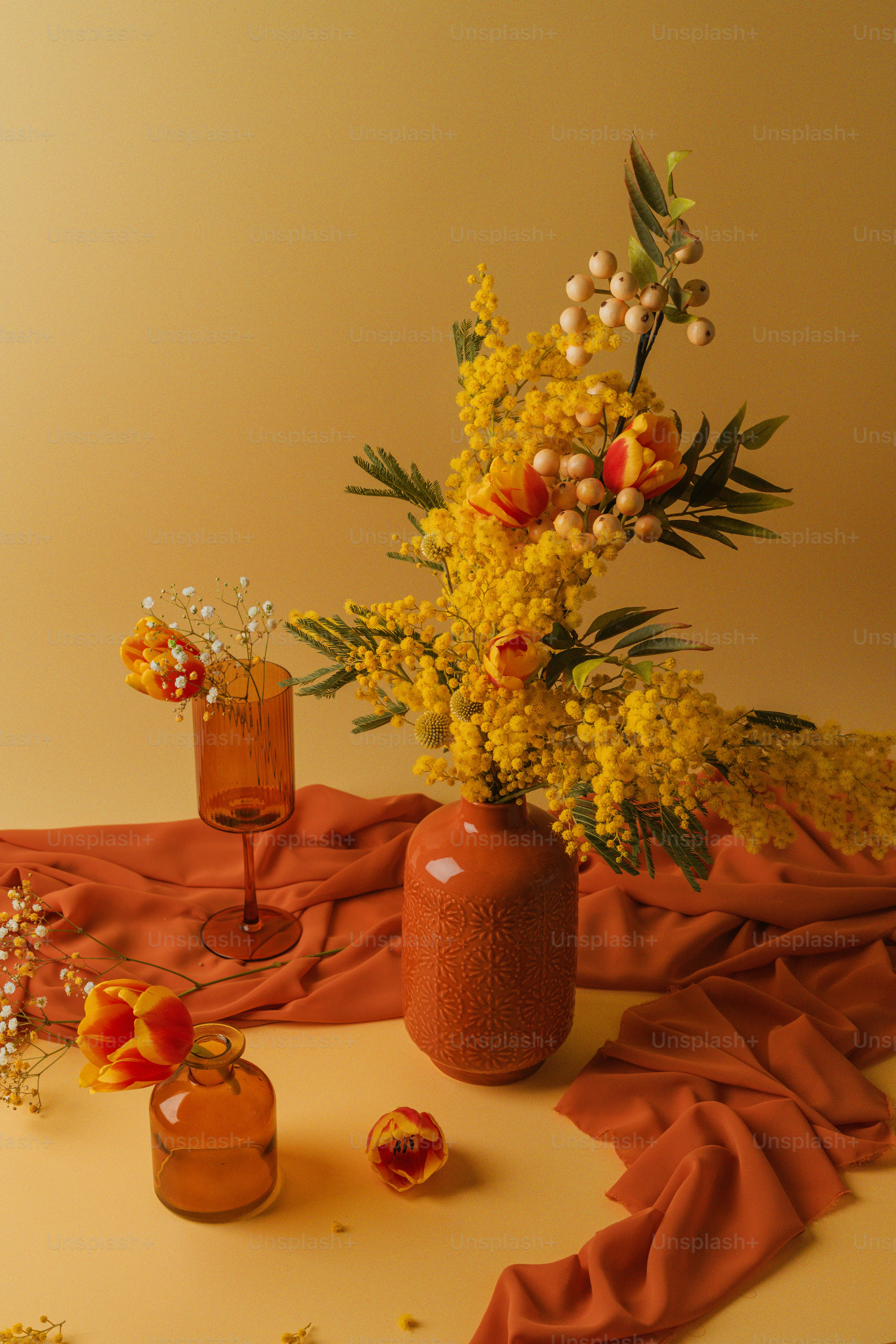 a vase filled with yellow flowers on top of a table