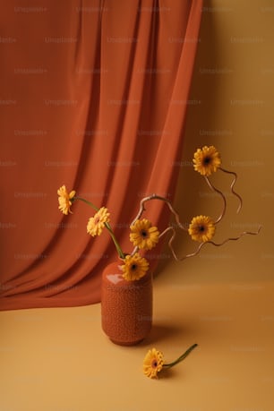 a vase filled with yellow flowers on top of a table