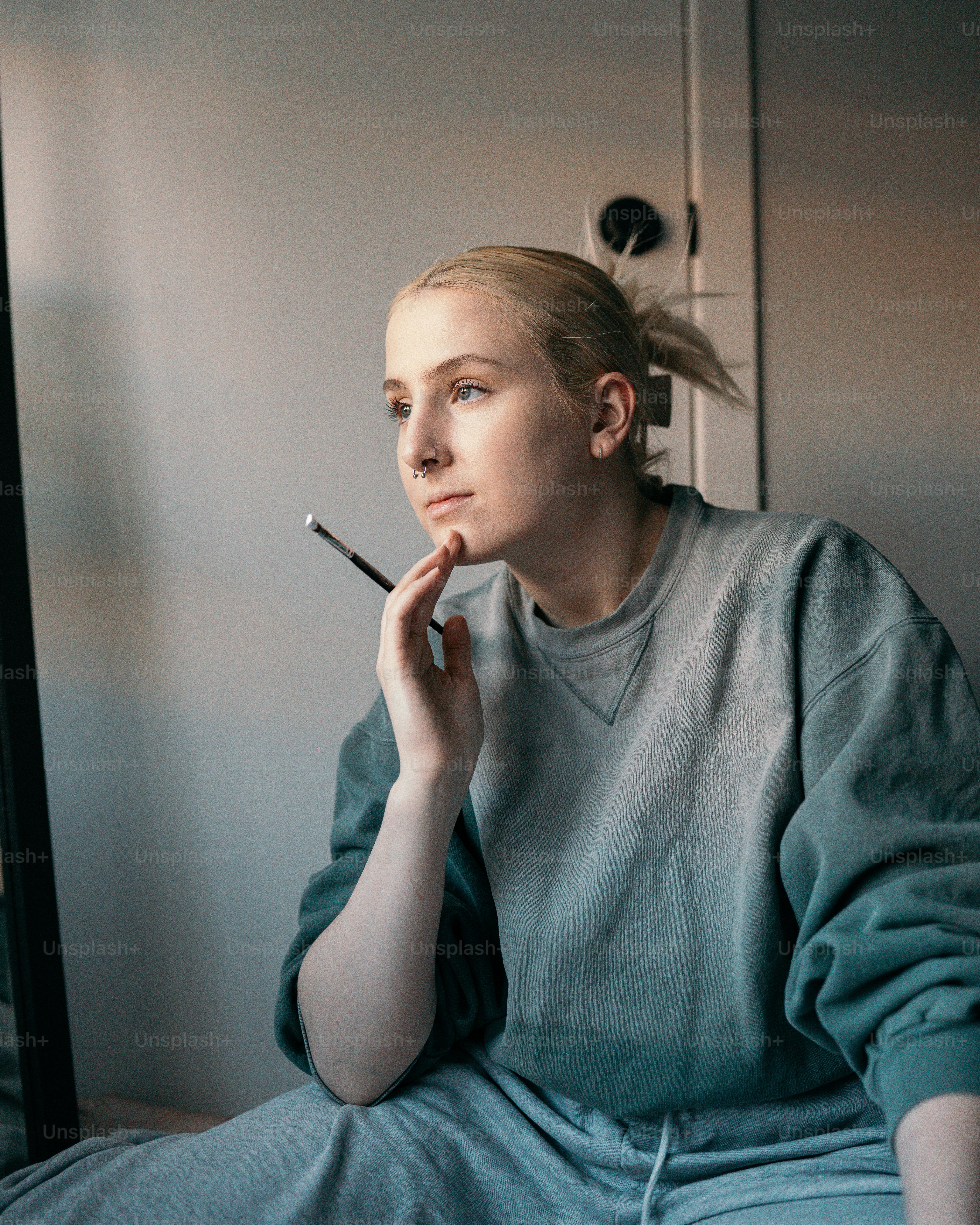 uma mulher sentada em uma cama fumando um cigarro