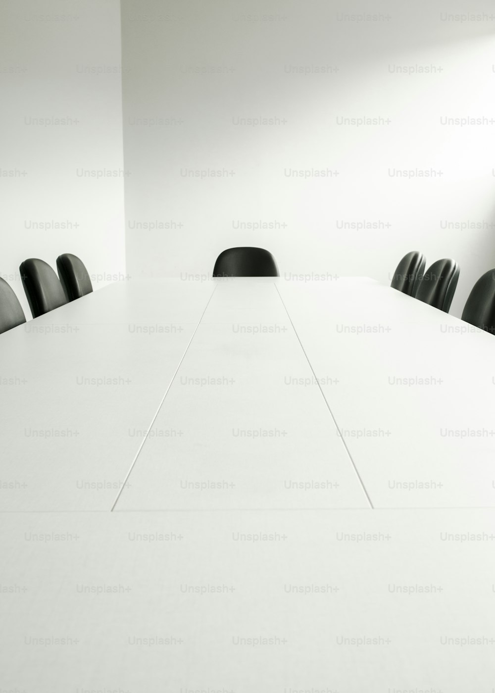 a white table with black chairs in a room