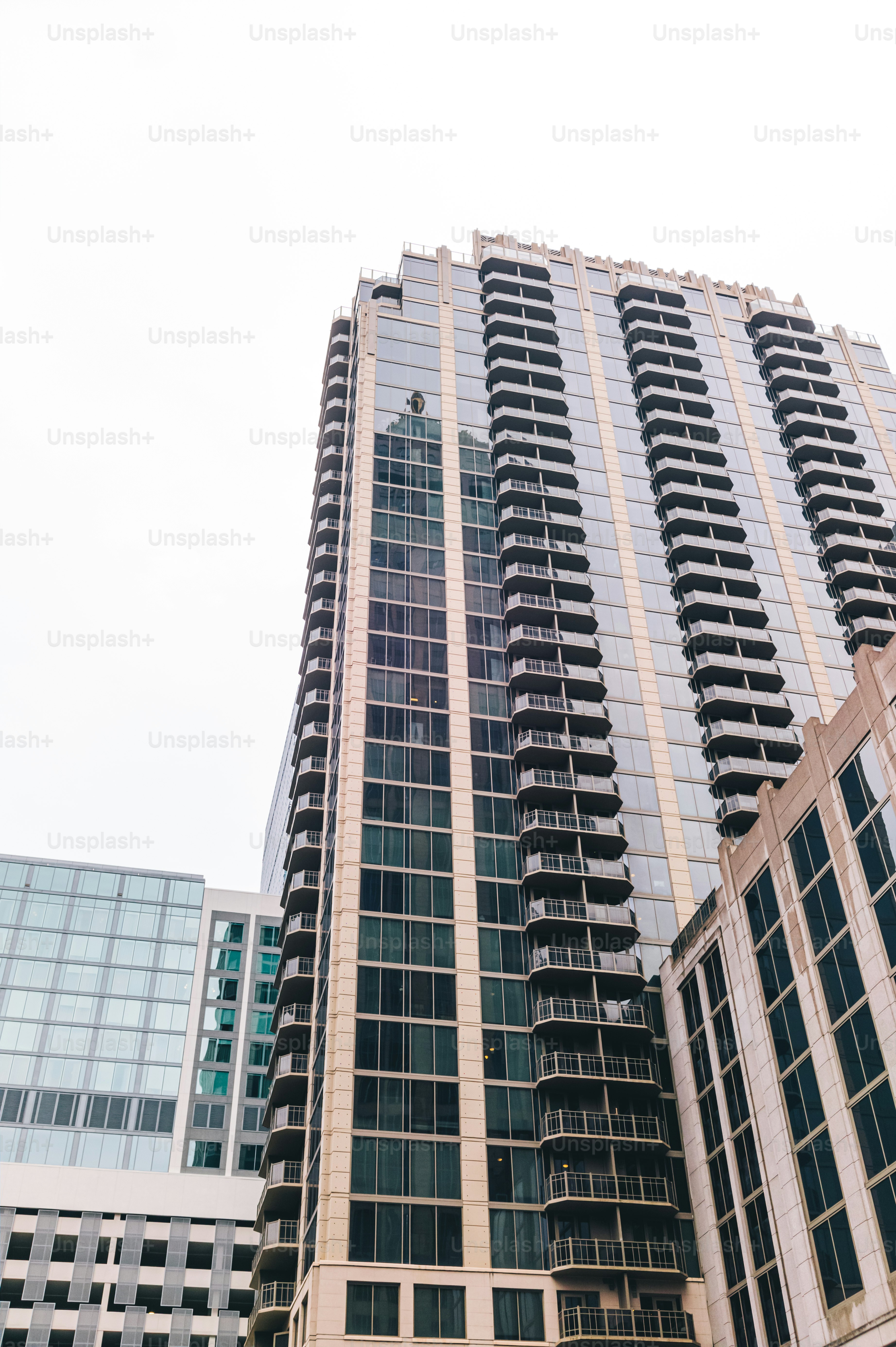 A couple of tall buildings sitting next to each other photo – City ...