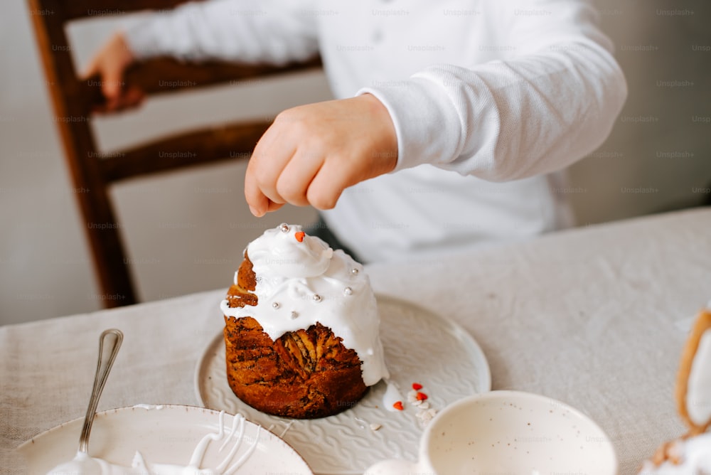 a person is putting icing on a piece of cake