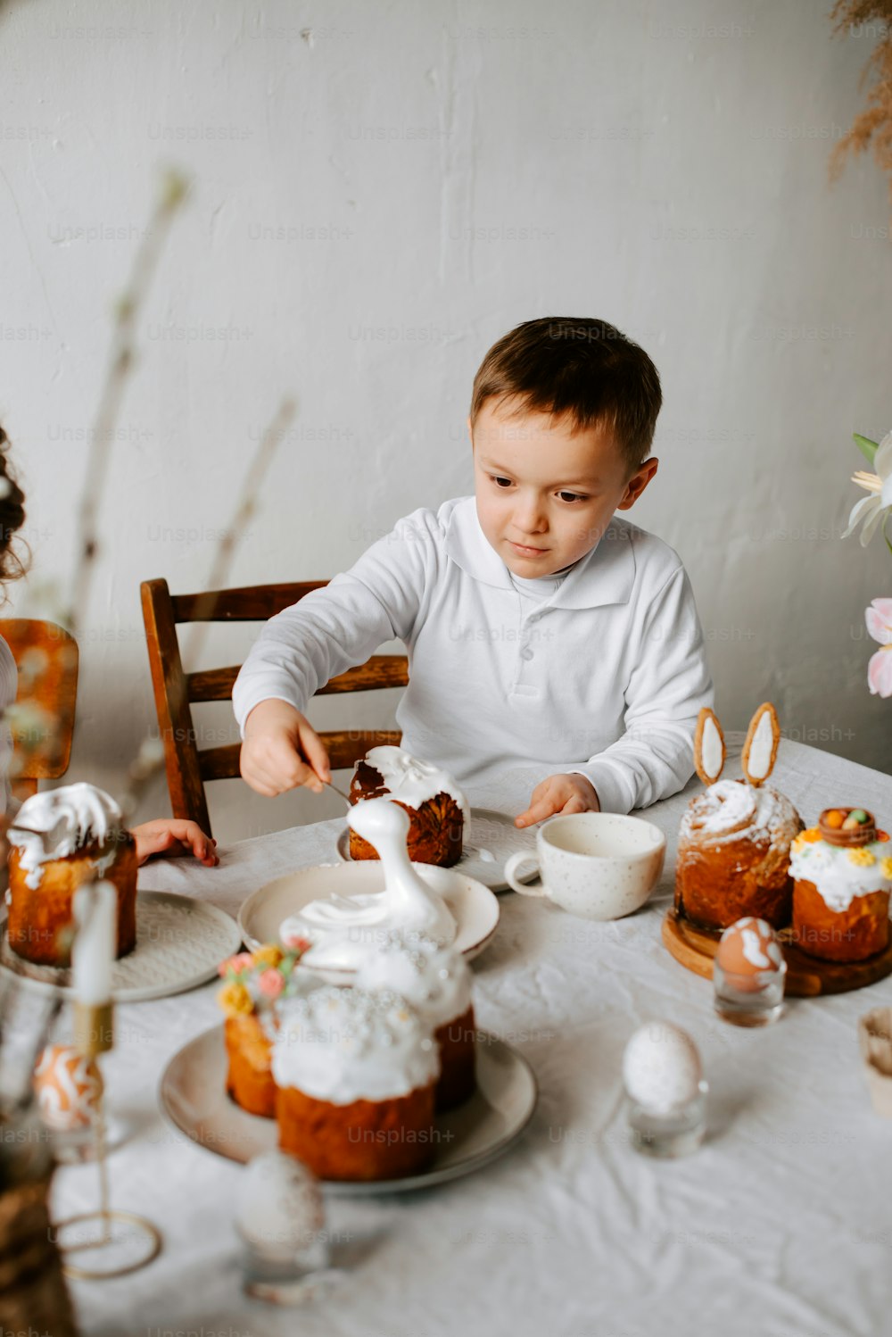 a little boy that is sitting at a table