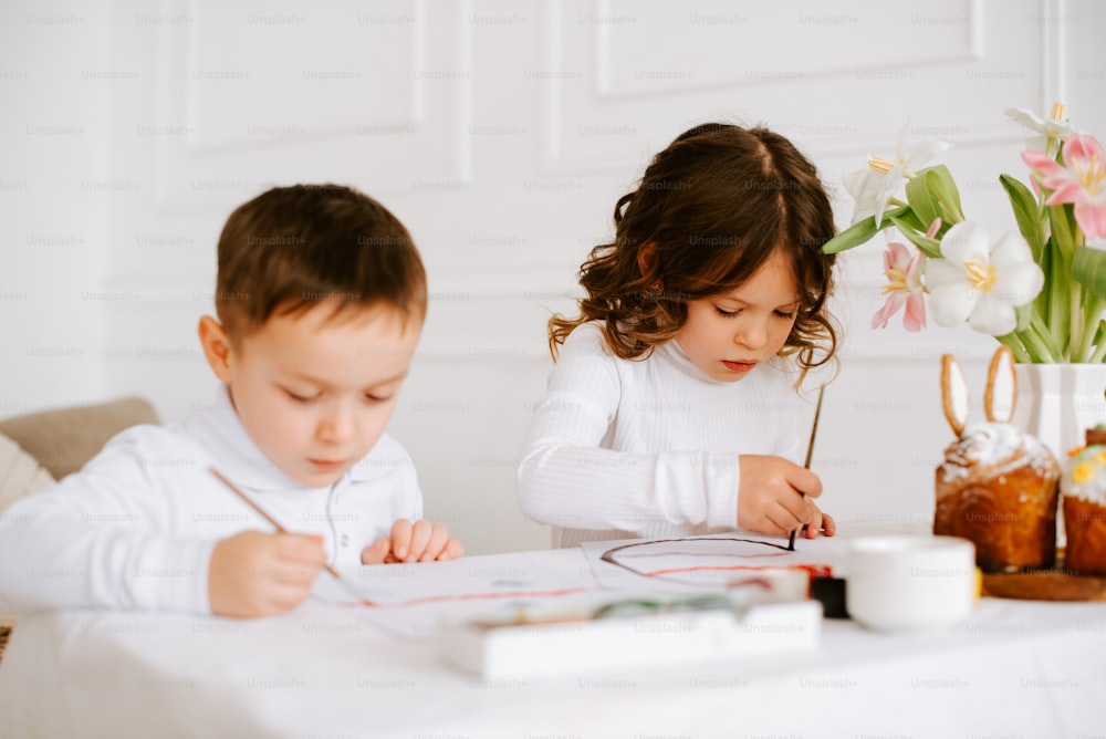 a boy and a girl are sitting at a table