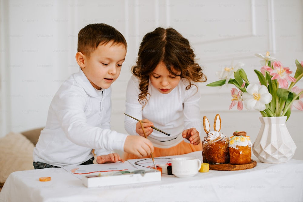 a couple of kids that are sitting at a table