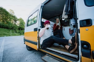 a couple of people sitting in the back of a van