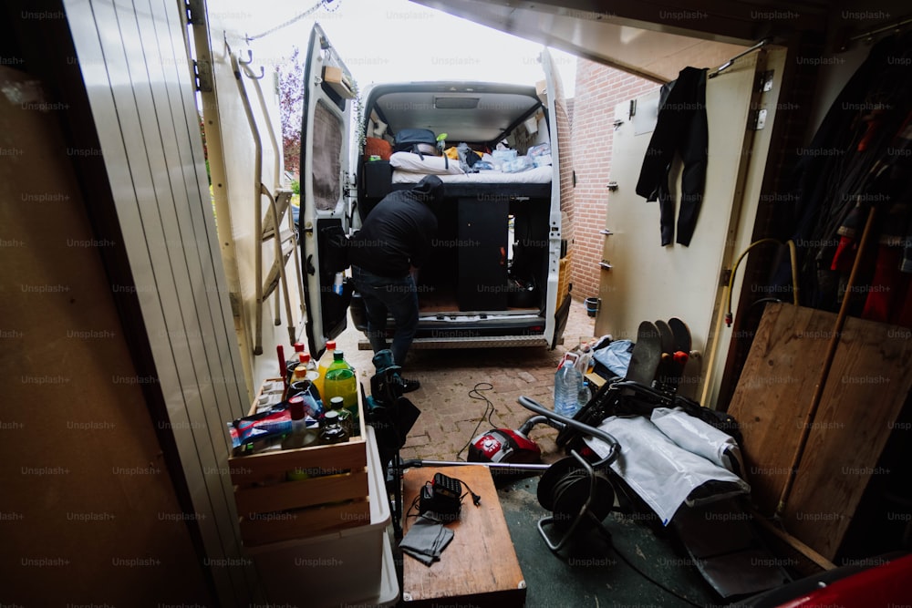 a man standing in the back of a van