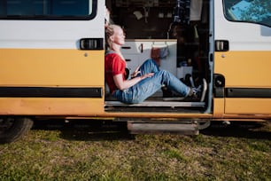 a man sitting in the back of a yellow van