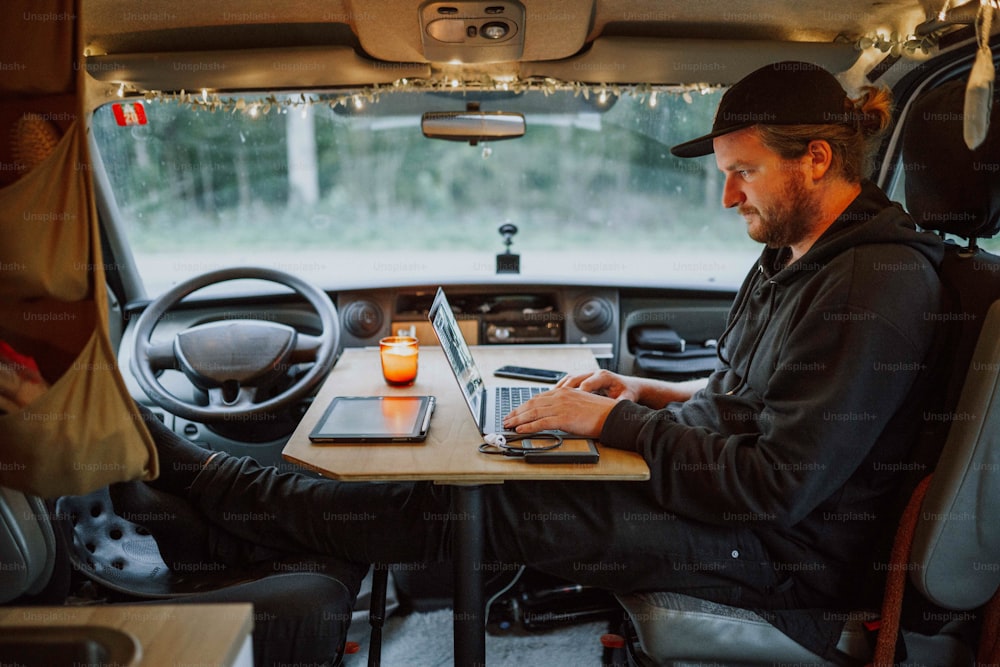 a man sitting at a table with a laptop