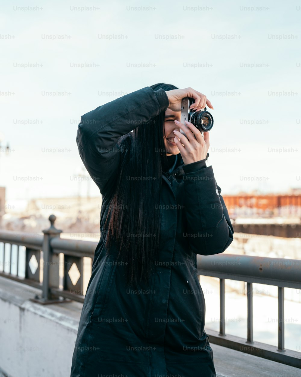 a woman taking a picture of herself with a camera