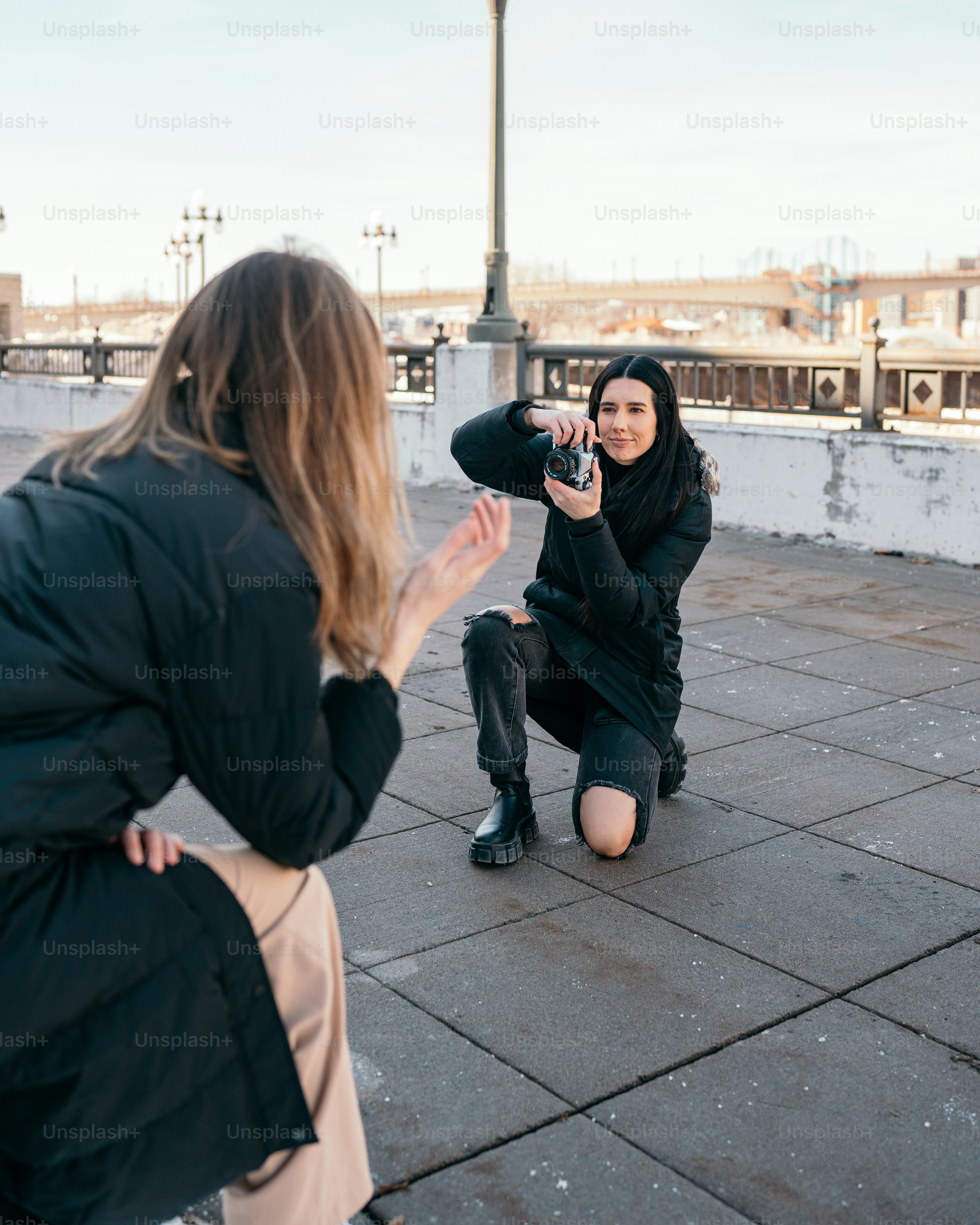 a woman taking a picture of another woman