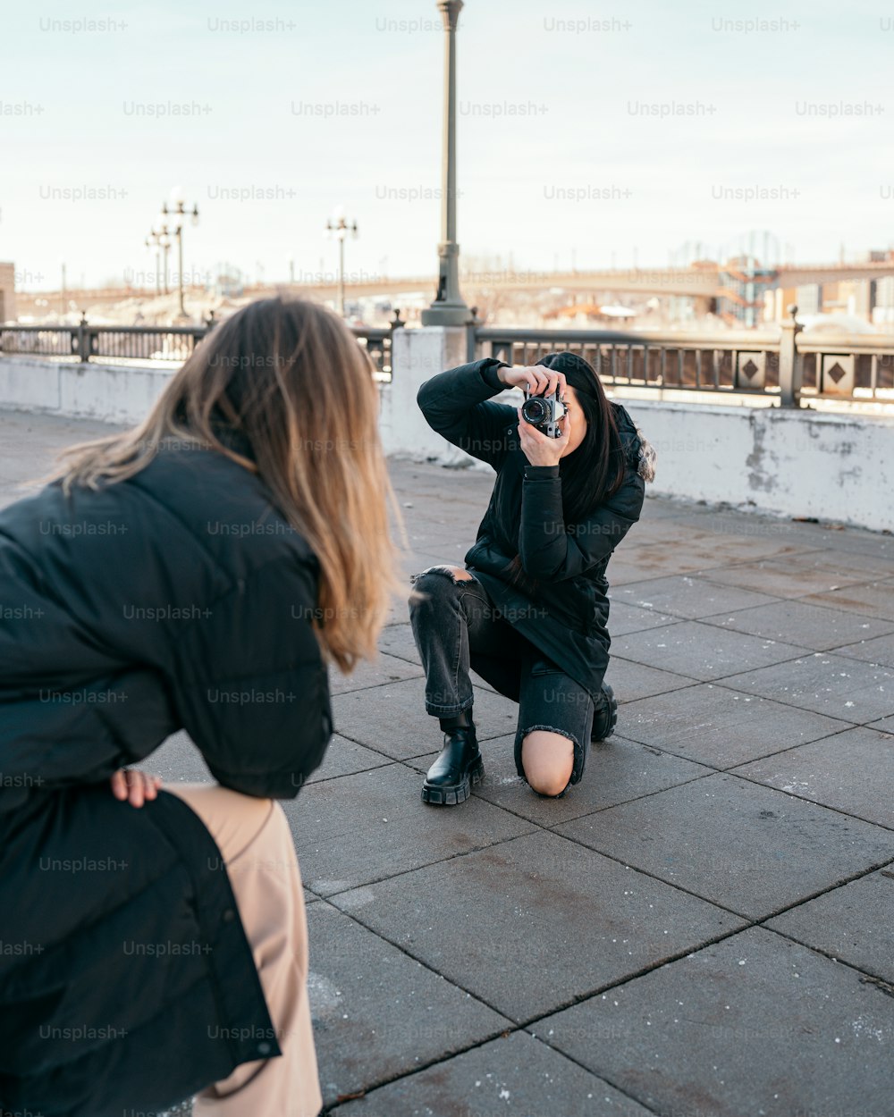 a woman taking a picture of another woman