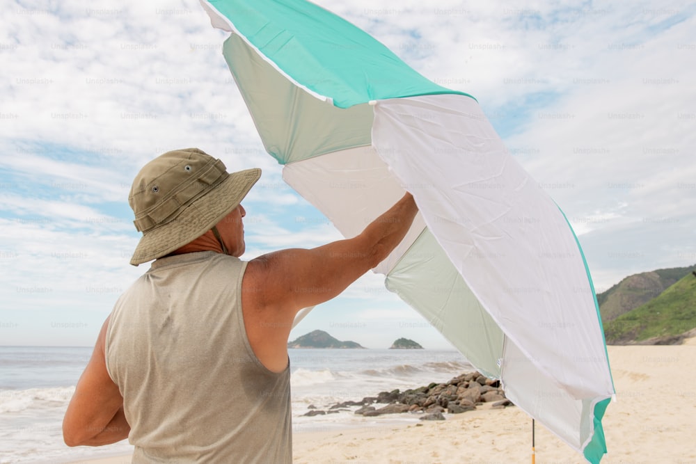 a man holding a kite on the beach
