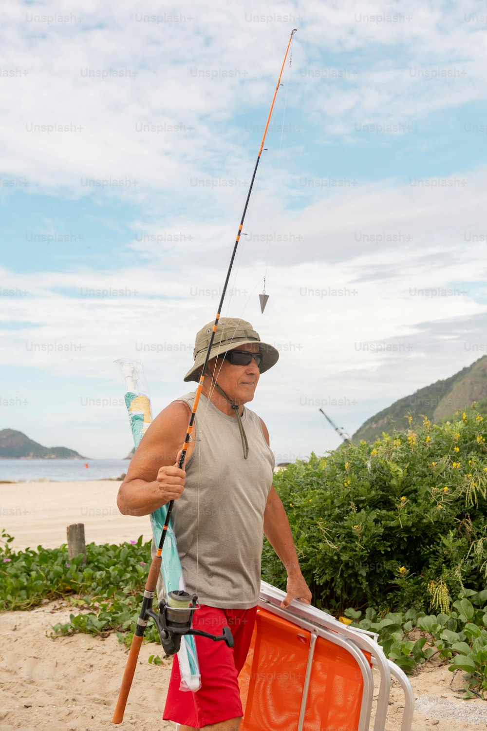 a man holding a fishing pole and a suitcase
