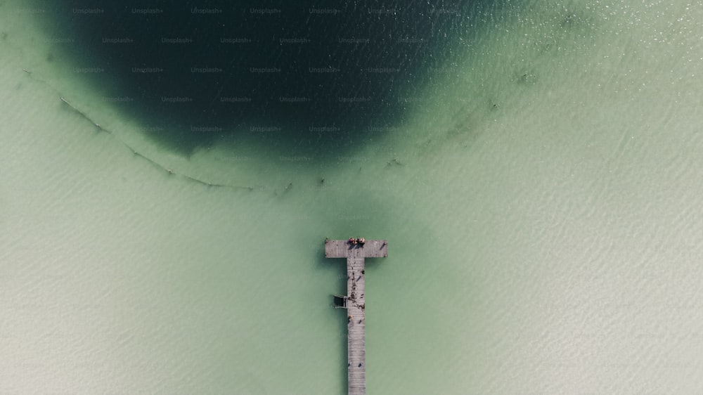 an aerial view of a cross on a beach