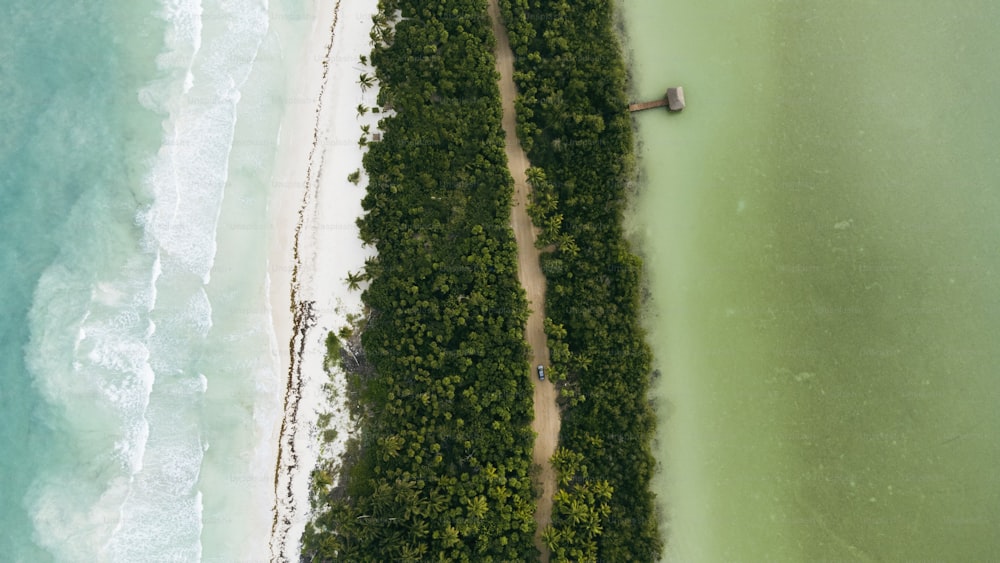 an aerial view of a beach with a boat in the water