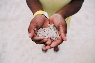 a person holding a handful of hail in their hands