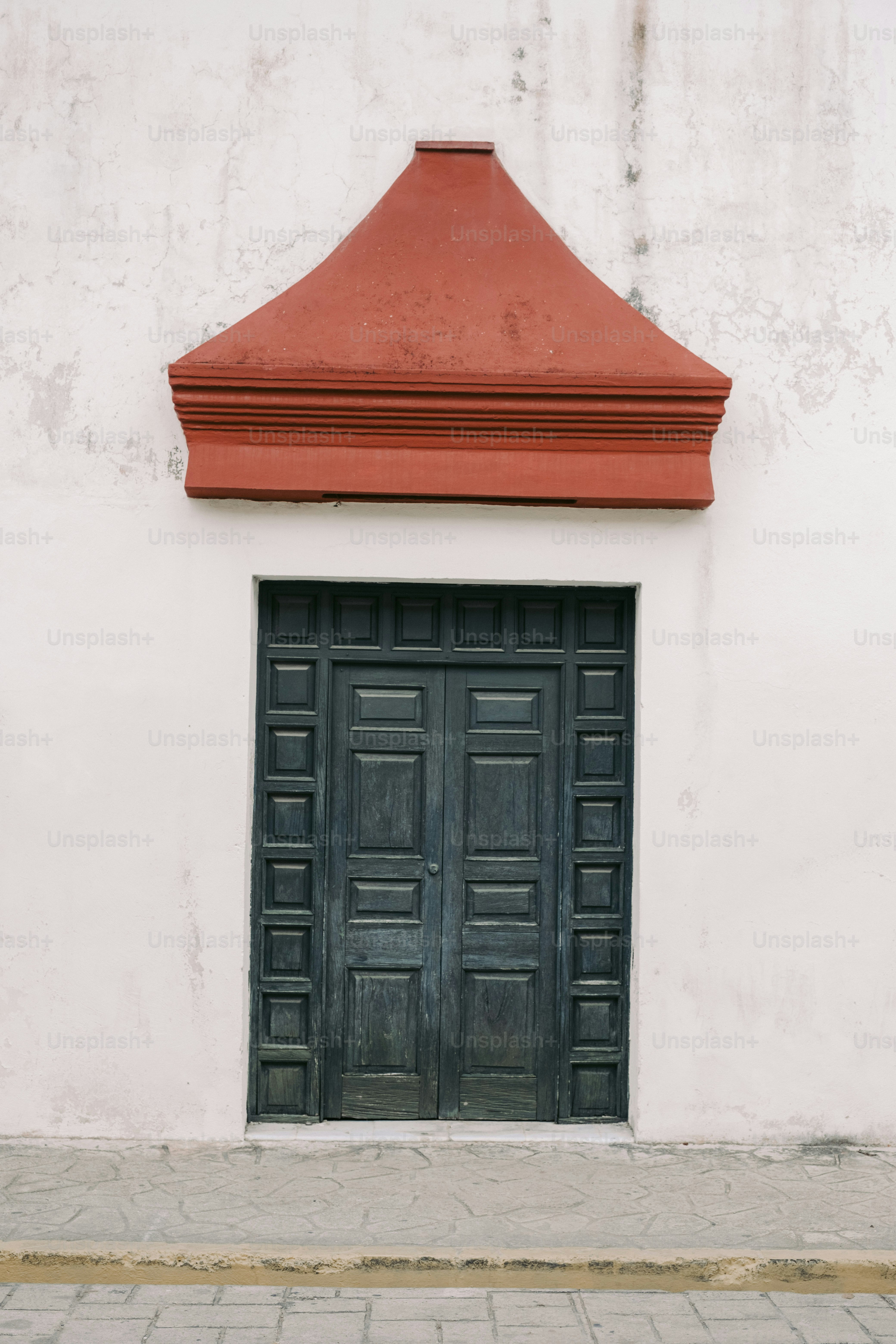 a fire hydrant sitting in front of a black door