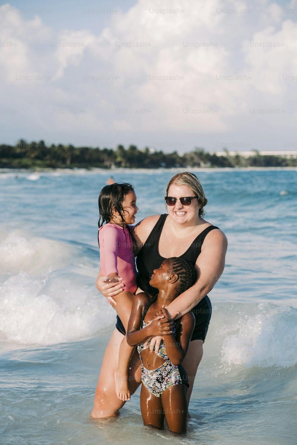 a woman and a little girl in the ocean