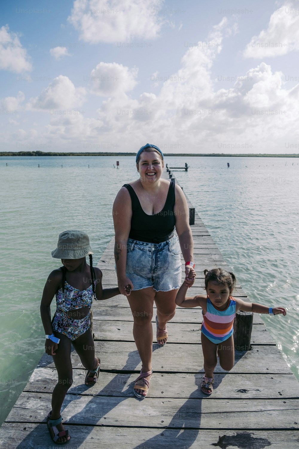 Eine Frau und zwei Kinder stehen auf einem Dock
