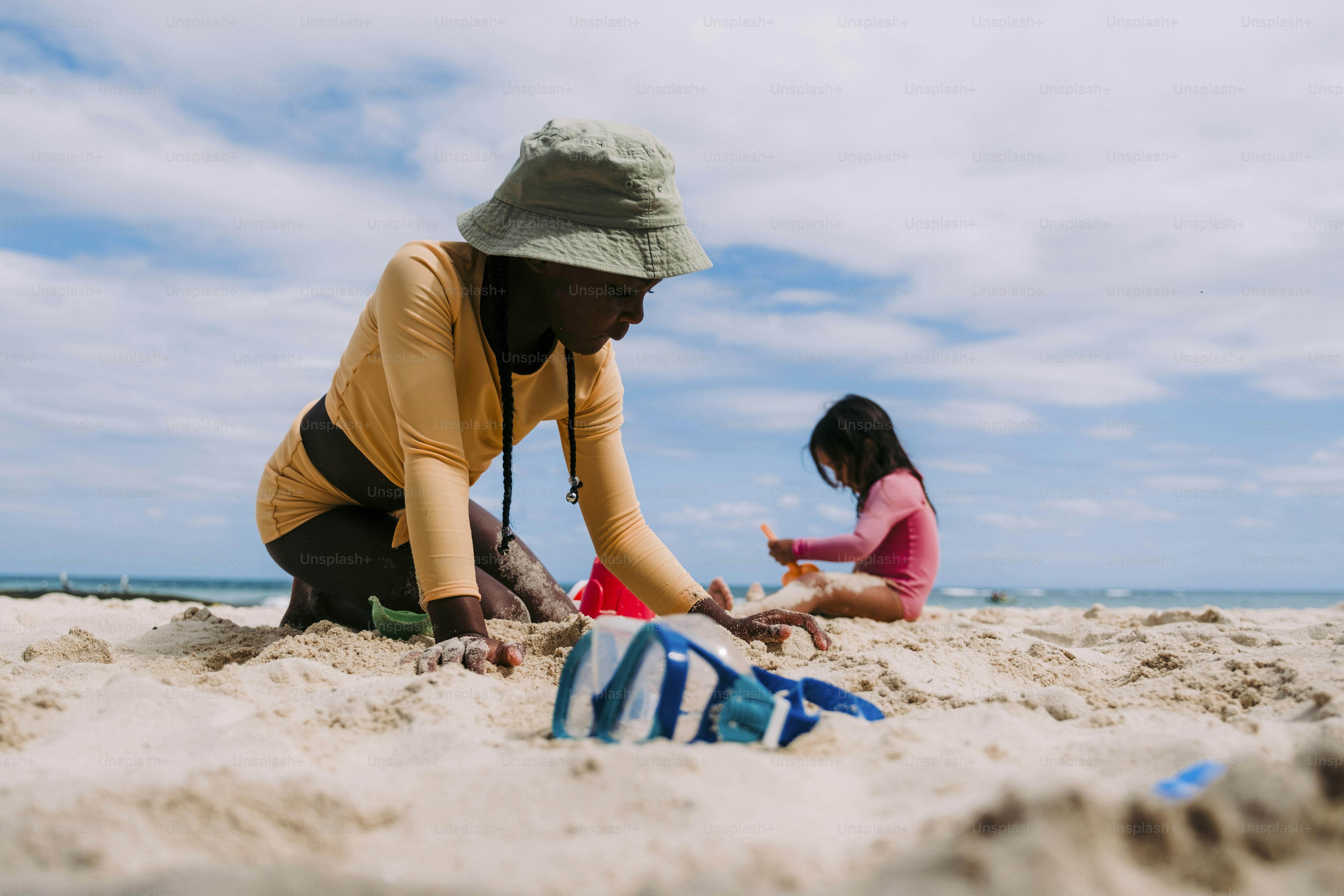 a man and a little girl playing in the sand