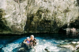 a couple of people in a small boat in a body of water