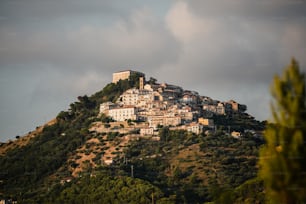 a large hill with a bunch of buildings on top of it