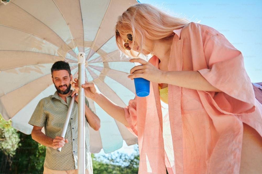 a man and a woman standing under an umbrella