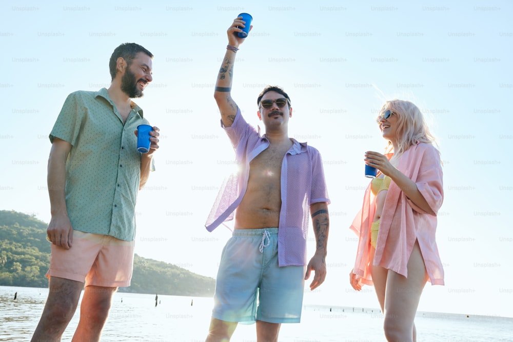 a group of people standing on top of a beach