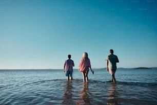 a group of people standing on top of a body of water