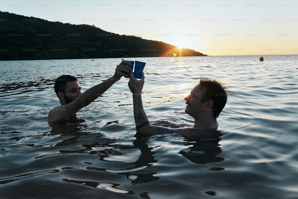 a couple of people in the water with a book